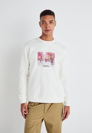 White sweatshirt featuring a central graphic of a New York street scene. Soft cotton fabric with long sleeves and a round neckline.
