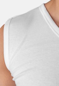 White sleeveless T-shirt with a V-neck, made from ribbed cotton fabric, featuring a smooth texture and clean stitching along the edges.
