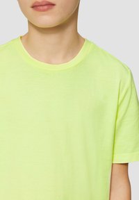 Neon gele t-shirt met een ronde hals, korte mouwen en een zachte, gladde textuur. Eenvoudig ontwerp zonder patronen of extra accenten.