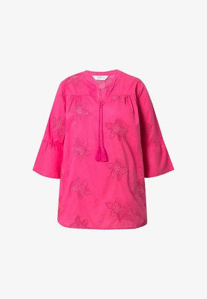 Roze tuniek met bloemenborduursels, V-hals en kwastjesdetails. Heeft driekwartmouwen en een relaxte pasvorm. Zachte stoftextuur.
