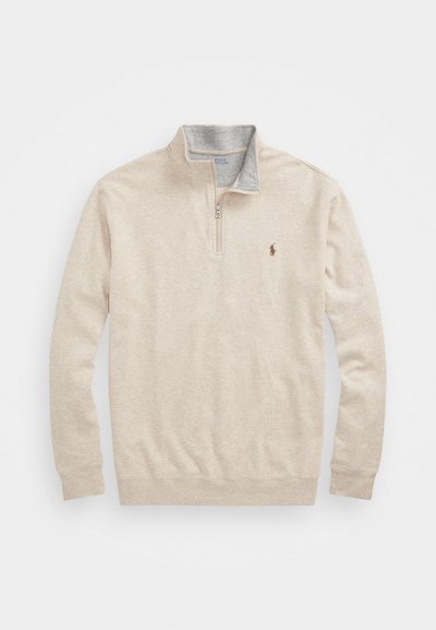 Beige zip-up pullover made of soft fabric, featuring a gray collar, ribbed cuffs, and a small embroidered logo on the chest.