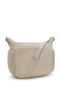 Beige crossbody bag featuring a textured surface, zippered pockets, adjustable strap, and silver hardware. Soft, lightweight material.