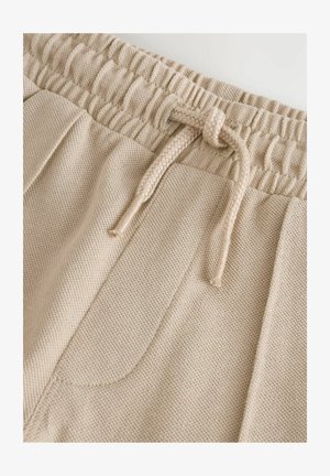 Pantaloni jogger bej, dintr-un material texturat, cu talie elastică și șnur de ajustare. Include două buzunare laterale.