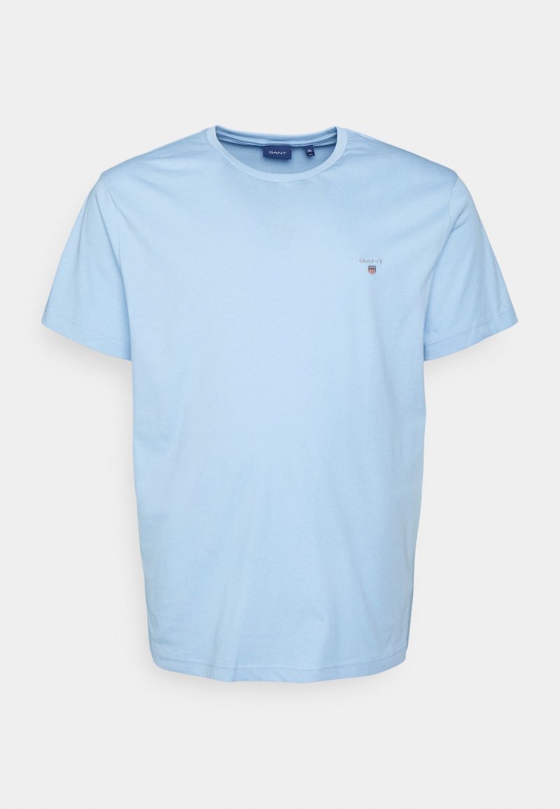 Ljust blå bomull t-shirt med rund halsringning, korta ärmar och en liten logotyp på bröstet. Slät textur och avslappnad passform.