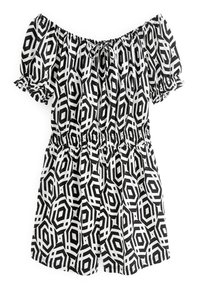 Vestido negro y blanco sin mangas con patrón geométrico, cinturilla elástica y mangas con volantes. Tejido ligero con una textura suave.