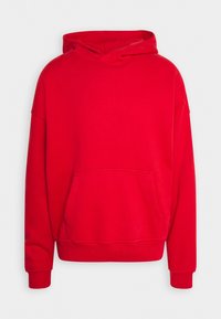Czerwona bluza z kapturem wykonana z miękkiego materiału. Posiada kieszeń kangurzą i ściągacze na rękawach. Luźny krój, prosty design bez wzorów.