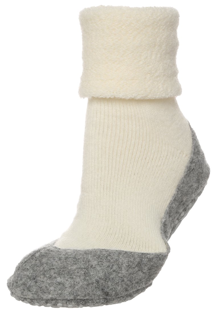 Calza lavorata a maglia crema con un polsino morbido e soffice, punta in feltro grigia e texture a coste lungo la gamba per comfort e calore.