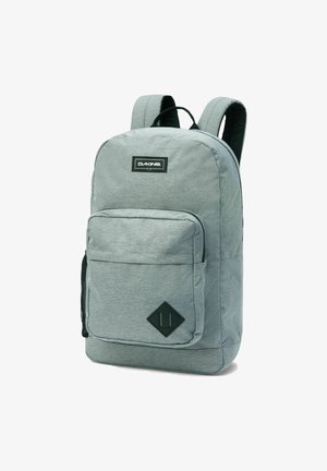 Grauer Stoff-Rucksack mit gepolsterten Trägern, einer Vordertasche und einem rhombusförmigen Akzent. Verfügt über ein Logo-Patch und eine strukturierte Oberfläche.