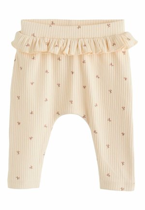 Ribbet, lyse beige leggings med en flæset talje. Har små lyserøde blomster mønstre over det hele. Blødt stof med en afslappet pasform.