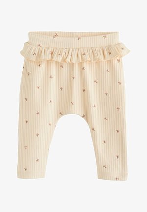 Ribbet, lyse beige leggings med en flæset talje. Har små lyserøde blomster mønstre over det hele. Blødt stof med en afslappet pasform.
