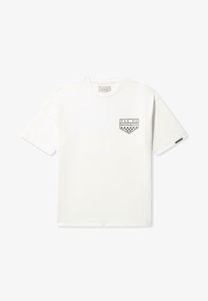 Weißes Baumwoll-T-Shirt mit einem kleinen schwarzen Grafikdesign mit "PAS DE MONACO" und einem Schachbrettmuster auf der linken Brust. Klassische Passform.
