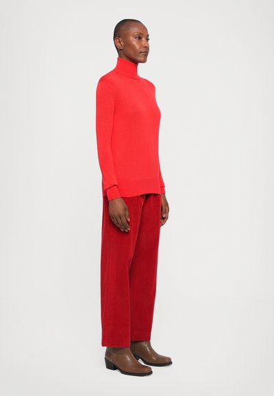 Red turtleneck sweater, paired with red wide-leg corduroy pants, and brown heeled ankle boots. Smooth texture, fitted top, and relaxed fit pants.