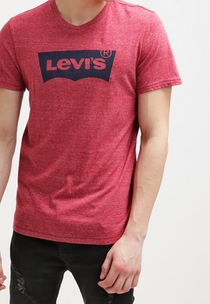 Czerwony t-shirt z krótkim rękawem z dużym granatowym logo "Levi's" na przodzie. Miękka tkanina z klasycznym okrągłym dekoltem.