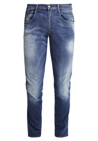 Mörkblå denimjeans med blekt tvätt, femficksdesign, metallknappar som stängning och kontrasterande sömdetaljer. Raka ben.