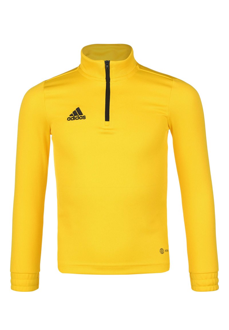 Maglietta sportiva gialla a maniche lunghe con colletto alto, chiusura a metà zip davanti e logo Adidas nero sul lato sinistro del petto. Tessuto liscio, design aderente.