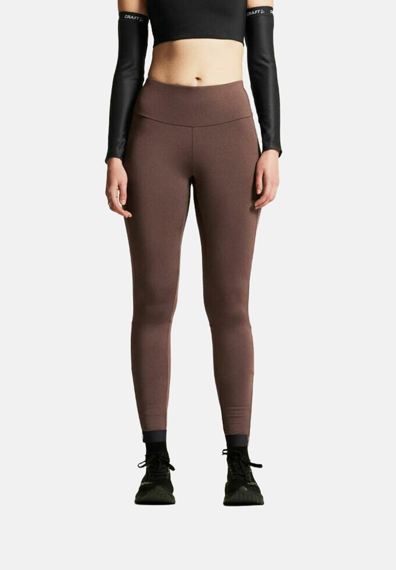 Braune Leggings aus dehnbarem Stoff mit glatter Textur, mit hohem Taillenbund und körpernahem Schnitt.