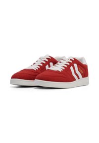Red suede sneakers with white laces, featuring three white stripes on the sides and a white rubber sole. Gold logo accent on the side.