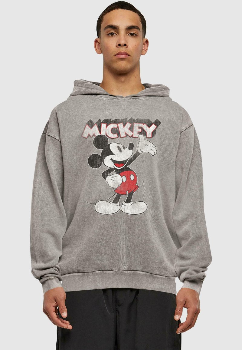 Šedá mikina z bavlny, s vintage grafikou Mickey Mouse na přední straně. Volnější střih, dlouhé rukávy a kapuce na stahovací šňůrku.