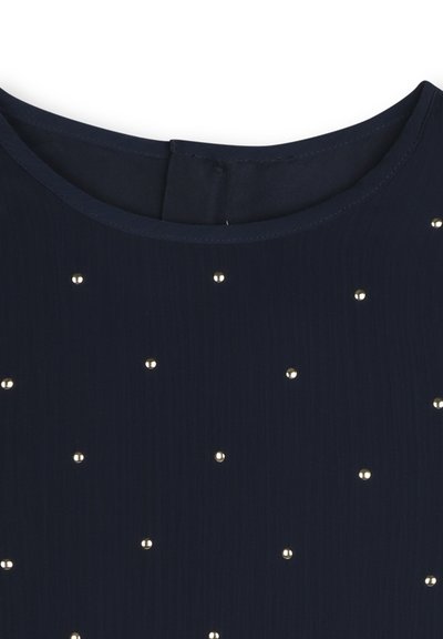 Tissu bleu marine avec une texture lisse, présentant des embellissements éparpillés en ton doré et un col rond. Fermeture éclair au dos.