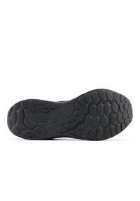 Black athletic shoe sole featuring a textured rubber surface with a honeycomb pattern and curved design elements for grip and traction.