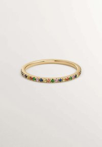 Anillo de banda de oro que presenta una fila de piedras preciosas de colores en varias formas. Textura suave con un acabado pulido, acentuando la vibrante tonalidad de las gemas.