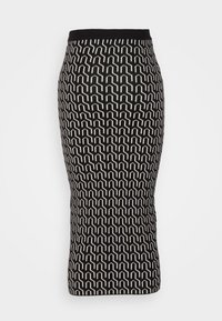 Jupe crayon noire et blanche longueur genou avec motif géométrique répétitif et taille ajustée sur fond uni.