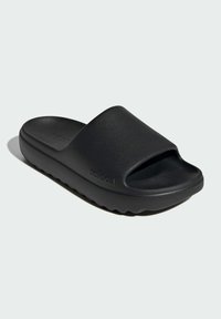Black slide sandal with a smooth matte finish, wide strap, and open toe design. Features a textured sole and subtle branding on the side.