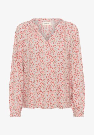 Floral blouse in light pink with long sleeves, a V-neckline, and gathers at shoulders. Features small red, blue, and green floral patterns.