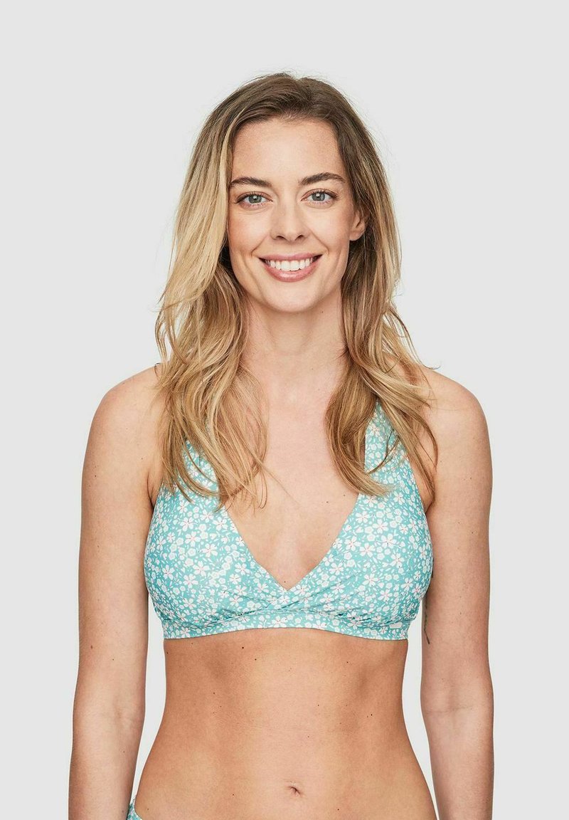 Mintgrön bikiniöverdel med vitt blommönster, triangelformad, djup V-ringning och justerbara band. Slät tygtextur.