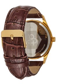 Brown textured leather strap, gold metal buckle, round watch face with glass and hexagonal backing, visible logo detail.