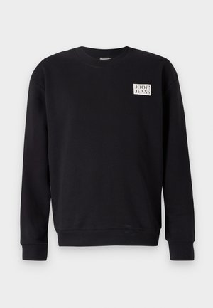 Felpa nera in cotone, con colletto girocollo, polsini e orlo a coste, e un logo quadrato bianco sul petto.