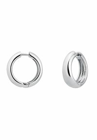 Pendientes de aro de plata con una superficie lisa y pulida y cierre sin costuras. Forma redondeada con un ligero grosor y detalles de textura interior.