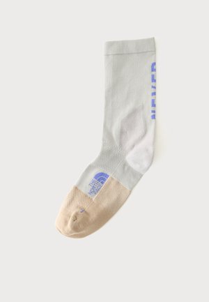 Single crew-length sock with beige toe and heel, light gray body, and blue "The North Face" logo and text on the side.