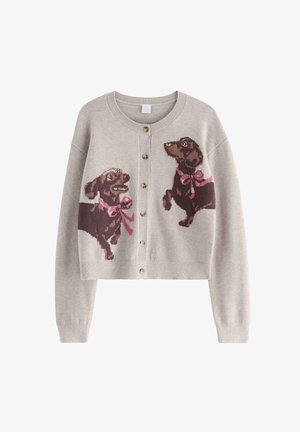 Beige cardigan with buttons featuring two brown dachshund dog designs wearing pink bows, one sitting and one standing.