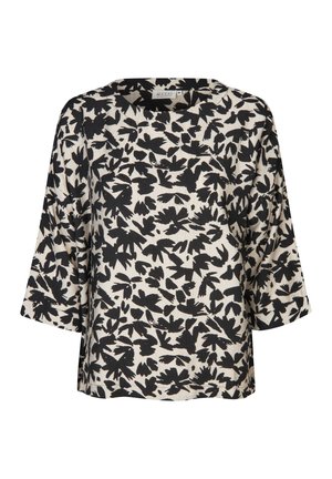 Losvallende top in beige met zwart bladerenpatroon, ronde halslijn en brede mouwen. Gemaakt van zachte stof met een lichte textuur. De zoom is recht.
