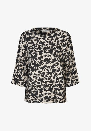 Haut fluide beige avec motif de feuilles noires, encolure ronde et manches larges. Confectionné dans un tissu doux à légère texture. Ourlet droit.