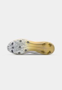 Football cleat outsole with a textured rubber surface, featuring black studs and a white base transitioning to yellow. Designed for grip.