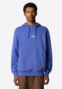 Blue hoodie made of cotton blend with a kangaroo pocket, ribbed cuffs, and a small white logo on the chest. Classic fit, soft texture.
