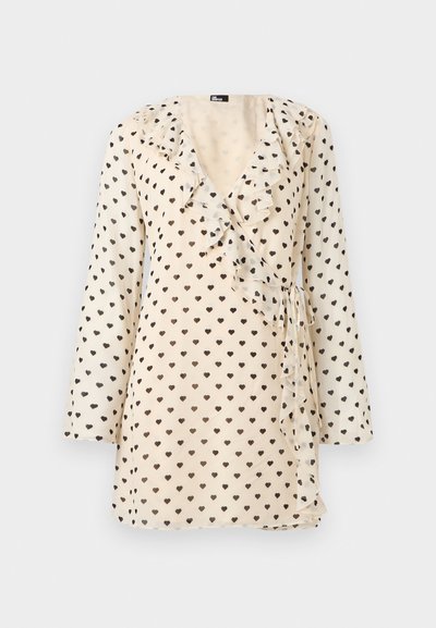 Φόρεμα τύπου wrap σε κρεμ απόχρωση με μακριά μανίκια, μοτίβο μαύρης καρδιάς, βολάν στο λαιμό και λεπτομέρεια δέσιμου στο πλάι.