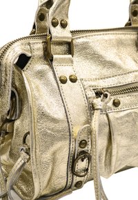 Sac à main en métal doré avec une finition texturée, équipé de matériel en bronze, de fermetures éclair et de coutures décoratives. Conception compacte avec plusieurs poches.