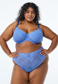 Light blue lace bra and high-waisted brief set featuring intricate floral and geometric patterns, with adjustable straps and soft texture.