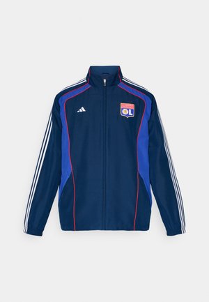 Navy blue tracksuit jacket with red and blue accents, featuring three white stripes on sleeves and an embroidered club logo on the chest.