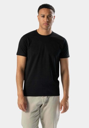Sort kortærmet T-shirt i en tætsiddende design, lavet af et glat stof med rund hals og uden synlige mønstre eller accenter.