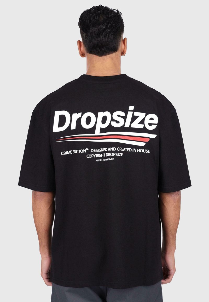Black cotton t-shirt featuring bold white lettering "Dropsize" and red accents, with a relaxed fit and short sleeves. Back view displayed.