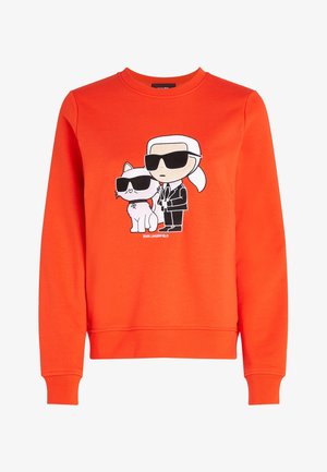 Sweat-shirt orange vif avec des personnages de dessin animé d'une personne et d'un chat, tous deux portant des lunettes de soleil noires à l'avant.