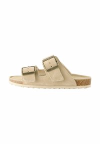 Beige Wildleder-Sandale mit zwei verstellbaren Schnallenriemen, Korkfußbett, strukturierter Außensohle für besseren Halt und minimalistischem Design.