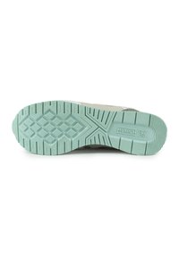 Schuhsohle aus leicht grünem Gummi mit einem strukturierten Muster, das winklige Formen zeigt und das eingestempelte "MUNIC"-Logo in der Mitte aufweist.