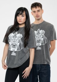 Gray short-sleeve t-shirts featuring a large white graphic design. The texture appears soft, with a relaxed fit and slightly worn look.