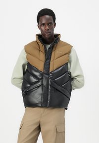 Helly Hansen VILLAGE PUFFY VEST UNISEX - Liemenė - sepia