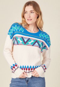 Cremefarbener Pullover mit blau, grün und rot geometrischen Mustern. Verfügt über einen runden Halsauschnitt und gerippte Säume. Weicher Stoff; lässige Passform.